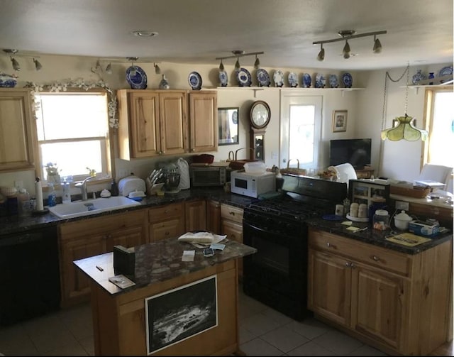 kitchen featuring light tile patterned flooring, sink, and black appliances