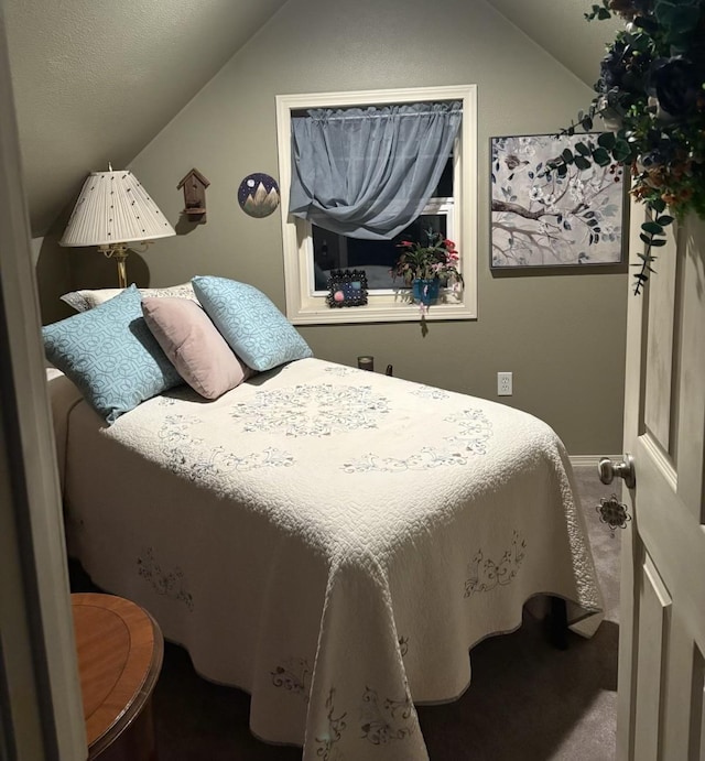 bedroom with lofted ceiling and carpet flooring