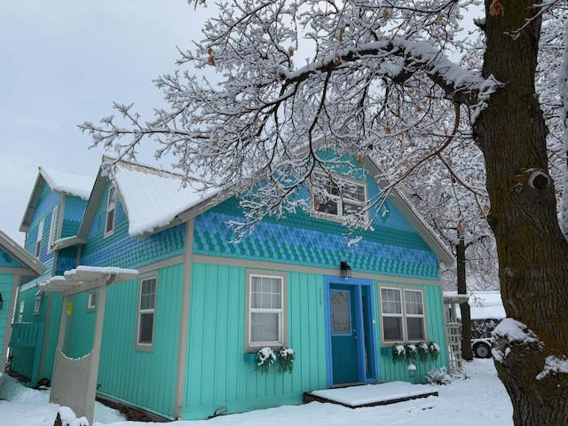 view of snow covered back of property