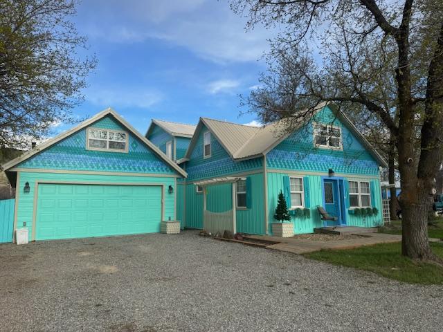 200 Clayton St, Plains, MT 59859 - view of front of house with a garage, driveway, and board and batten siding