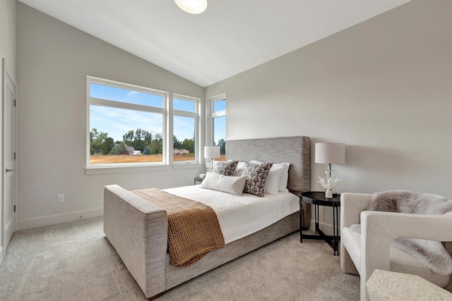 carpeted bedroom with lofted ceiling