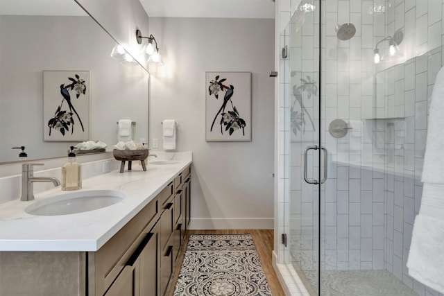 bathroom featuring vanity, hardwood / wood-style flooring, and walk in shower