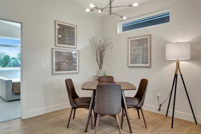 dining space with a notable chandelier and light wood-type flooring