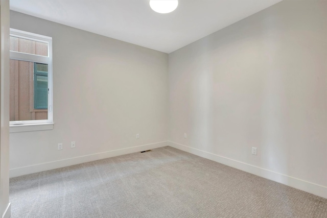 spare room with light colored carpet