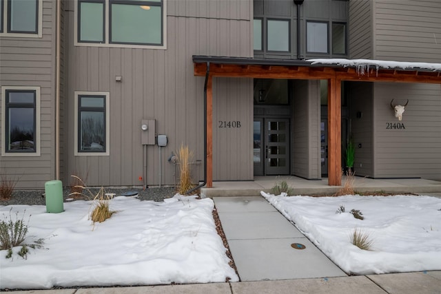 view of snow covered property entrance