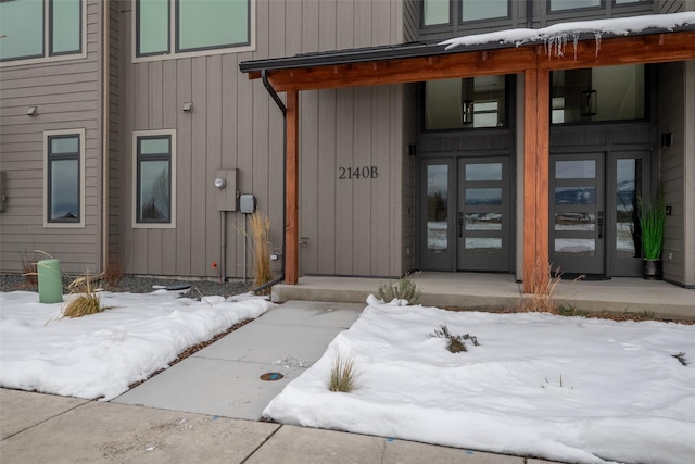 view of snow covered property entrance