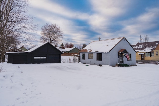 view of front of home featuring a garage, a carport, and an outdoor structure