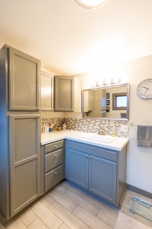 bathroom with vanity and tasteful backsplash