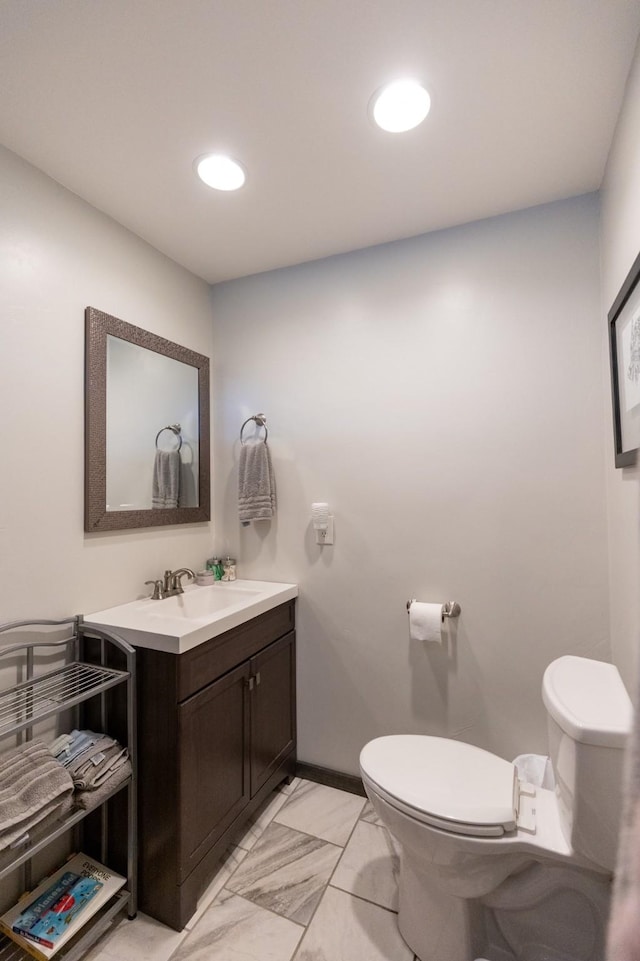 bathroom featuring toilet and vanity