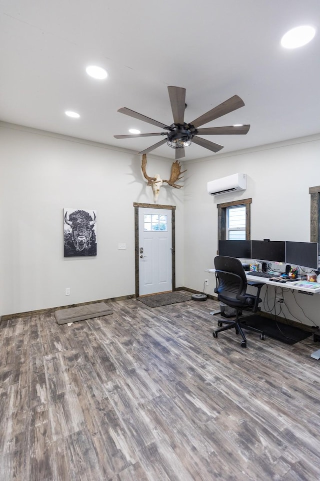 office space with a wall unit AC, ceiling fan, crown molding, and hardwood / wood-style floors