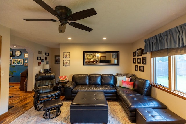 living room featuring ceiling fan and wood-type flooring