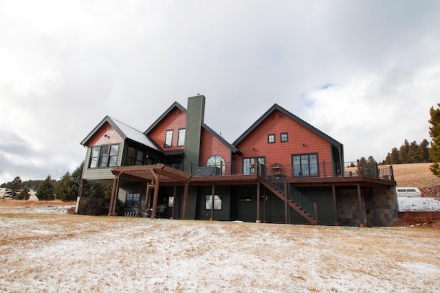 back of house featuring a wooden deck