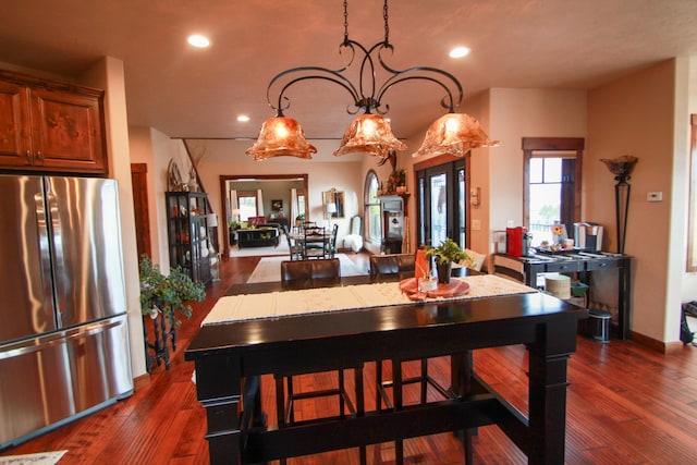 dining room with dark hardwood / wood-style flooring and a chandelier