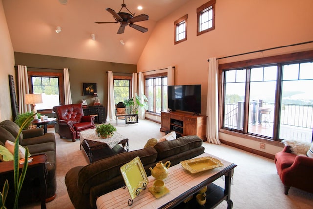 living room featuring ceiling fan, light colored carpet, and plenty of natural light