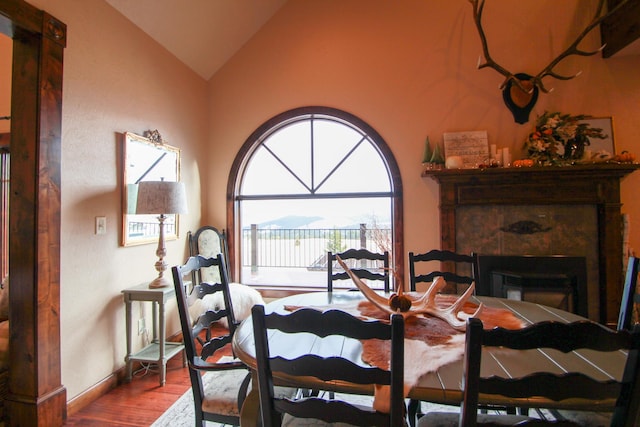 dining area featuring lofted ceiling and hardwood / wood-style floors