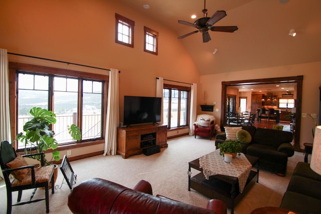 carpeted living room featuring high vaulted ceiling and ceiling fan