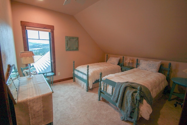 carpeted bedroom with lofted ceiling