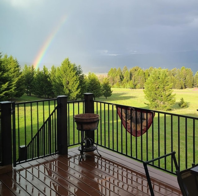 wooden terrace with a lawn