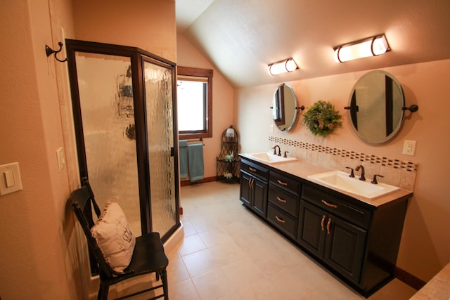 bathroom with vanity, lofted ceiling, and decorative backsplash