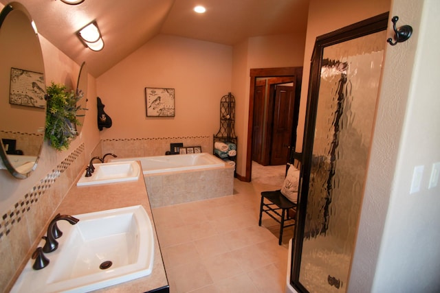 bathroom with sink, tile patterned floors, vaulted ceiling, and plus walk in shower