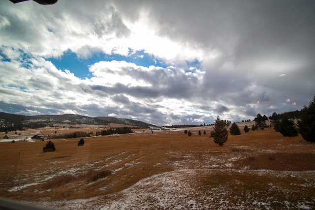 view of local wilderness with a rural view and a mountain view