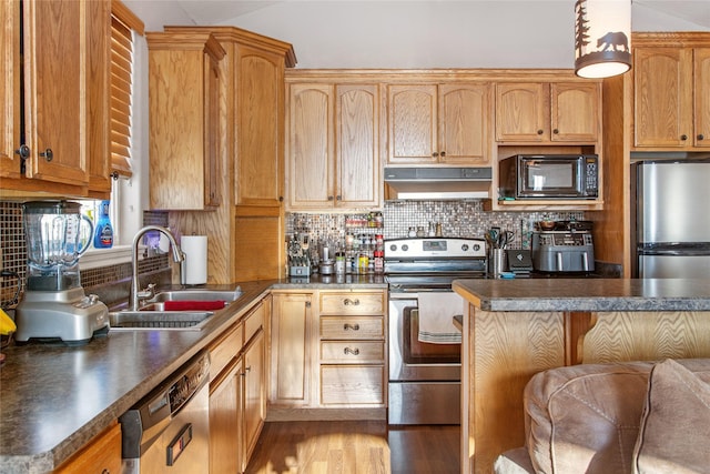 kitchen with appliances with stainless steel finishes, light hardwood / wood-style floors, backsplash, and sink