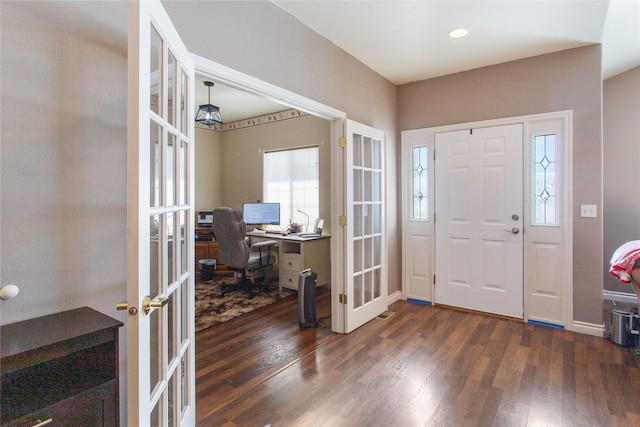 foyer entrance featuring french doors and dark hardwood / wood-style floors