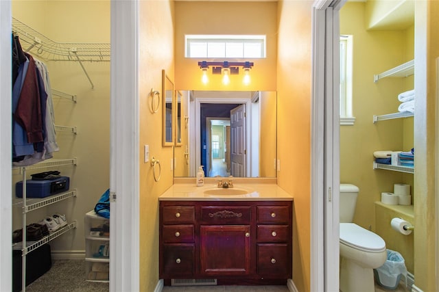 129 Red Mountain Vw, Butte, MT 59701 - bathroom featuring a spacious closet, toilet, vanity, and baseboards