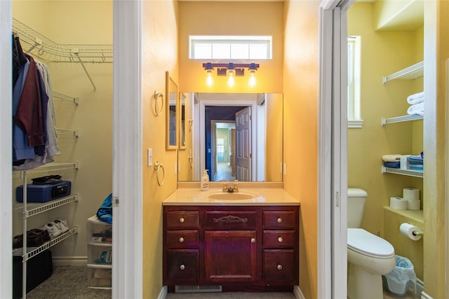 bathroom with toilet and vanity