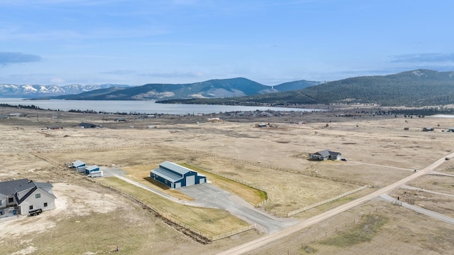 birds eye view of property with a water and mountain view and a rural view