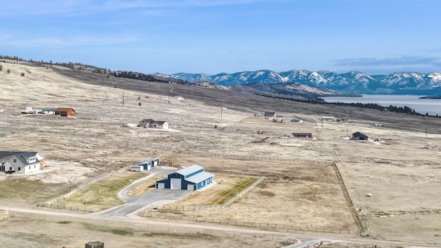 birds eye view of property with a water and mountain view and a rural view