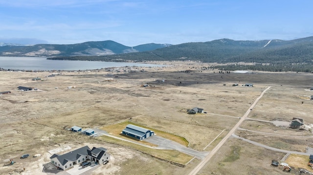 birds eye view of property with a water and mountain view