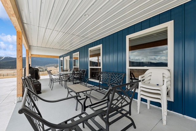 view of patio with a mountain view and grilling area