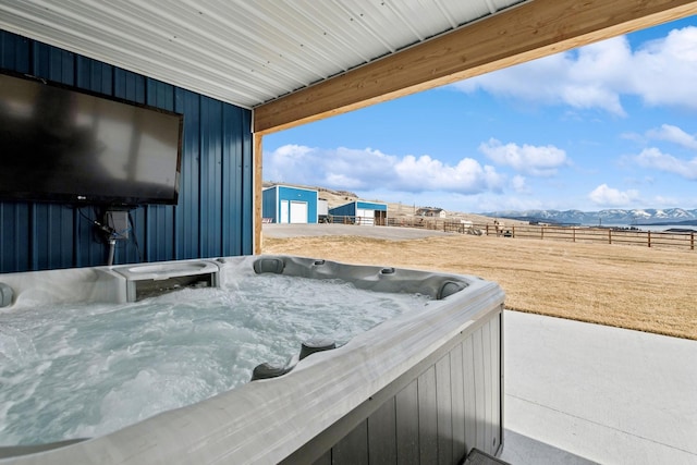 view of patio / terrace featuring a mountain view and a hot tub