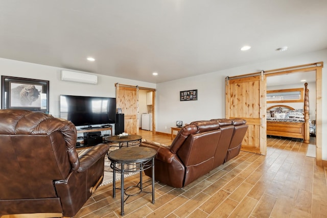 living room featuring an AC wall unit and a barn door