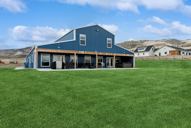 rear view of house with a patio and a yard