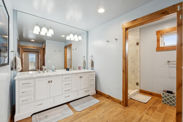 bathroom with tiled shower and vanity