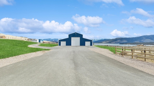 view of road with a rural view and a mountain view