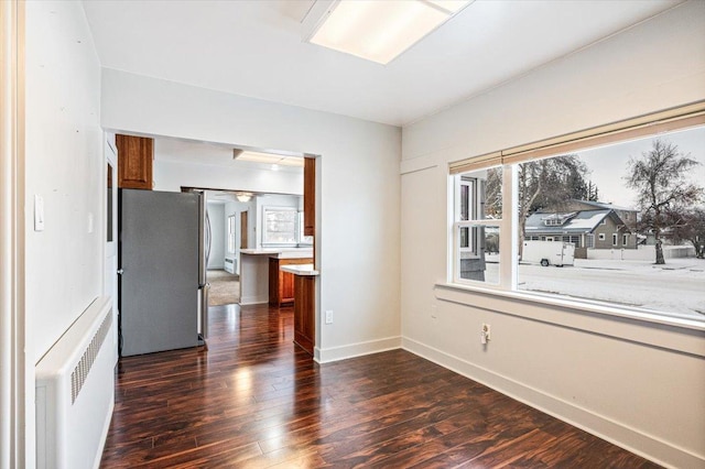 interior space featuring radiator heating unit and dark hardwood / wood-style floors