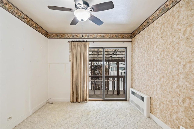 empty room with radiator, carpet flooring, and ceiling fan