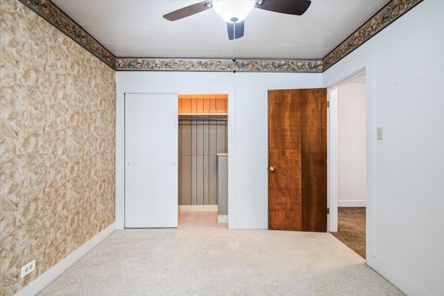 unfurnished bedroom featuring carpet floors, ceiling fan, and a closet