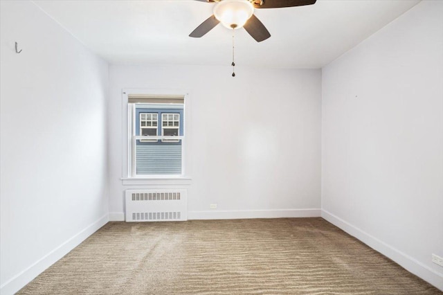 unfurnished room featuring radiator and ceiling fan