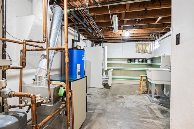 basement featuring sink, water heater, and white fridge