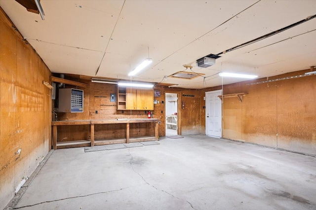 garage featuring a garage door opener and a workshop area