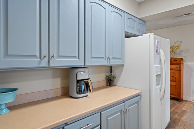 kitchen featuring light hardwood / wood-style floors and white fridge with ice dispenser