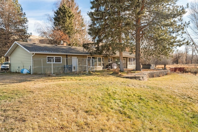 rear view of property with a yard