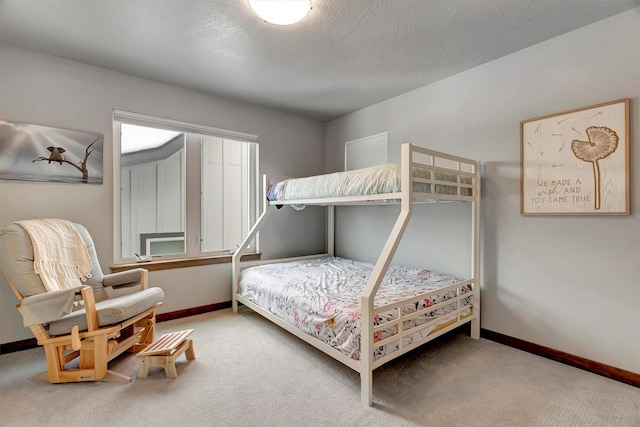 bedroom featuring carpet floors and a textured ceiling