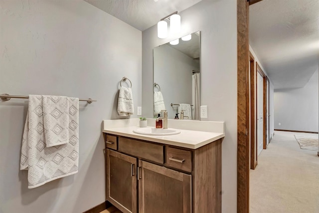 bathroom with a textured ceiling and vanity