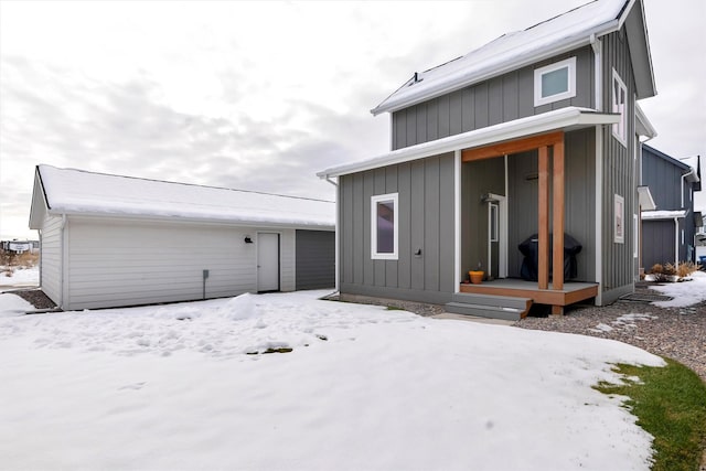 view of snow covered rear of property