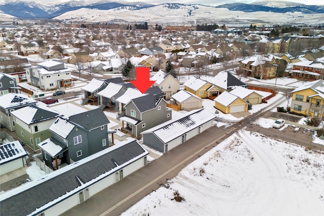 snowy aerial view with a mountain view